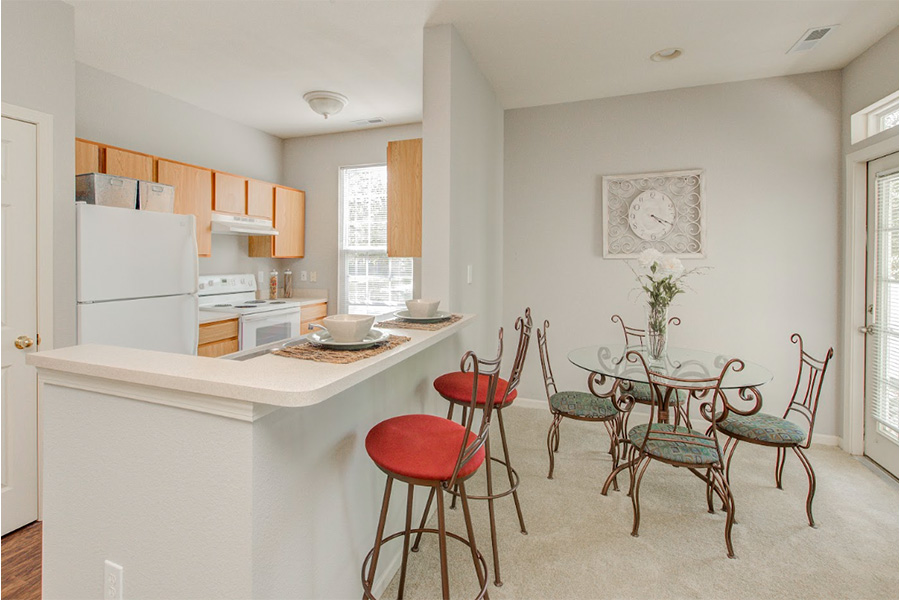 Dining room with round table and four chairs in compact space