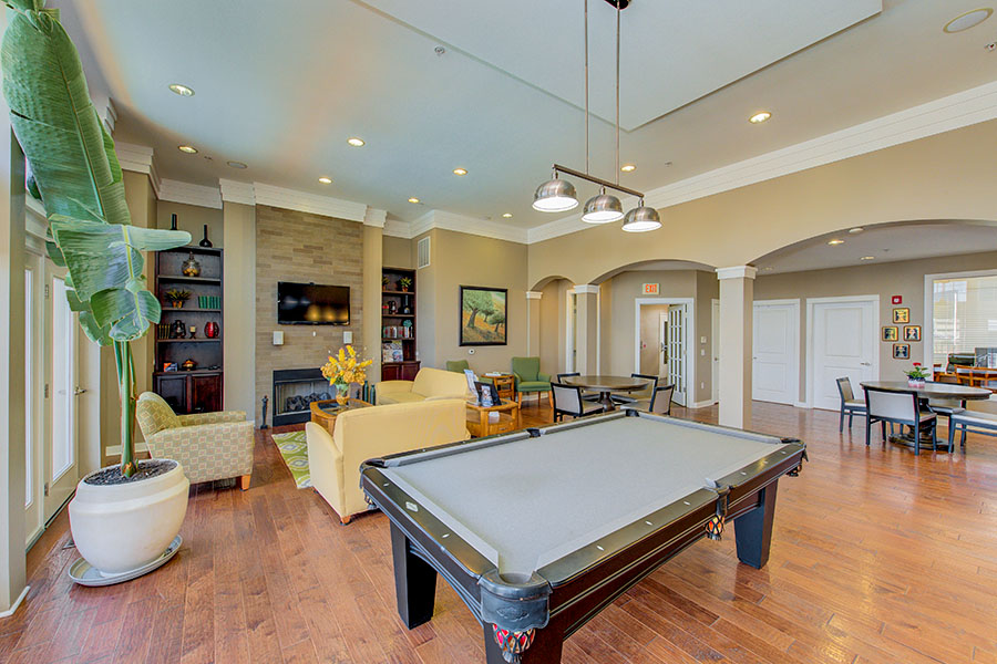 A high-ceilinged rec room with pool table at Waverley Apartments.
